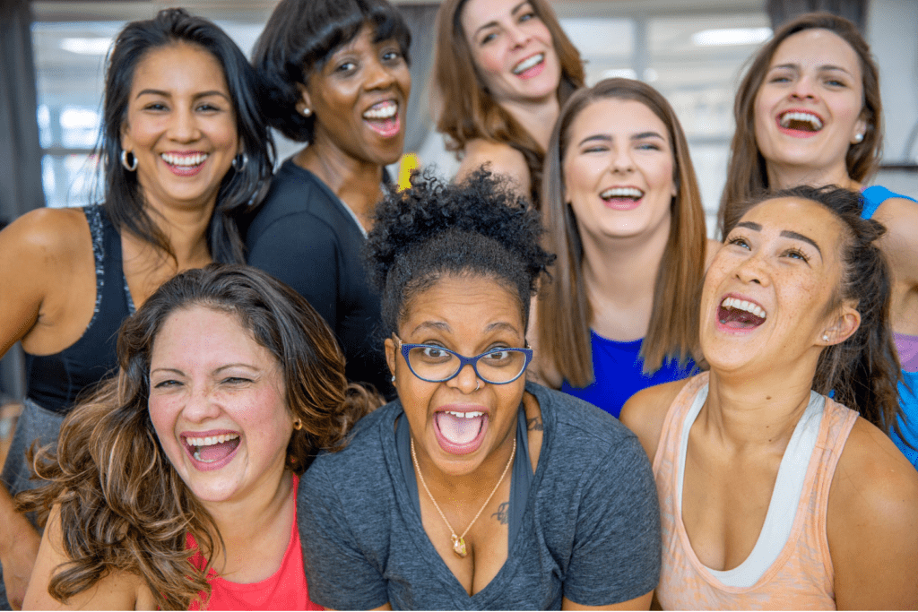 A group of smiling women of different ethnicities